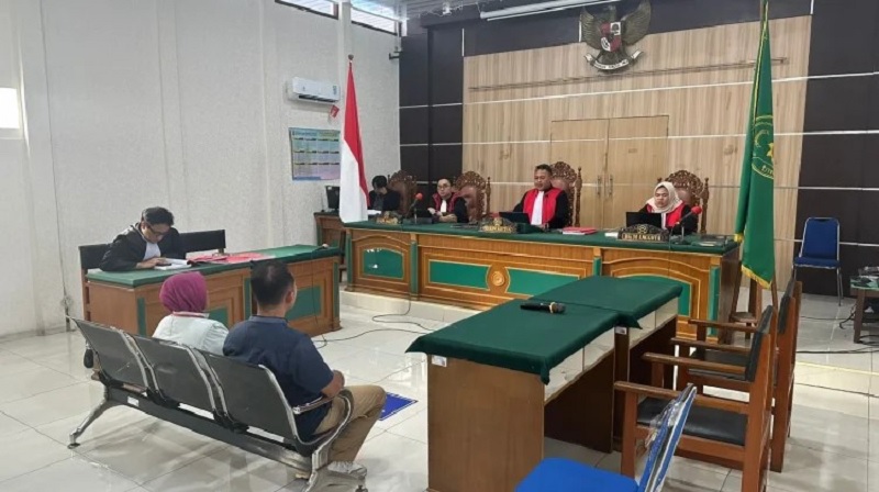 Terdakwa duduk dengan wajah tertunduk mendengarkan putusan majelis hakim dalam perkara kekerasan terhadap anak yang digelar di PN Bengkalis, Selasa (10/3/2026).