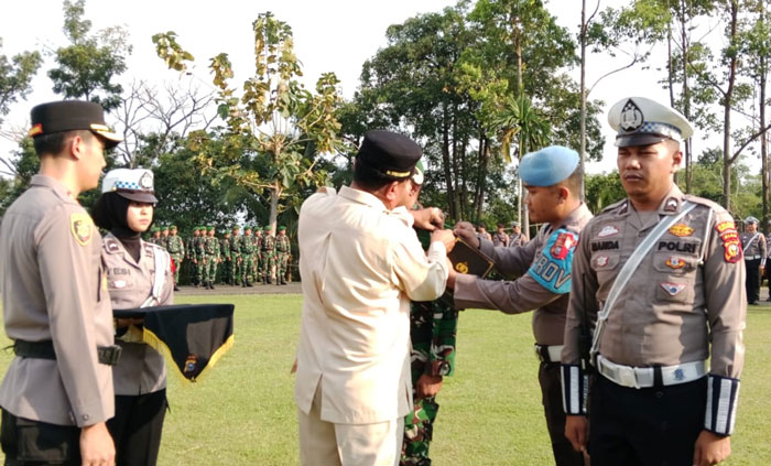 Bupati Kuansing Dr H Suhardiman Amby MM didampingi Kapolres Kuansing AKBP Hidayat Perdana SH SIK MH, memasangkan pita secara simbolis saat gelar pasukan operasi Ketupat Lancang Kuning 2026