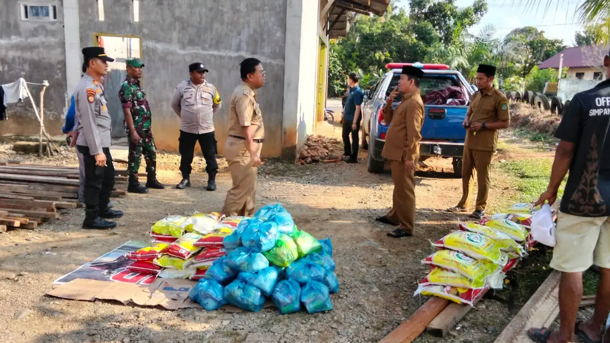 Wabup Rohul H Syafaruddin Poti berbincang dengan Camat Kabun Anang Perdhana Putra saat menyerahkan&nbsp;bantuan sembako untuk puluhan kepala ke­luarga di Desa Aliantan yang rumahnya terdampak bencana angin puting beliung, Selasa (31/3/2026). (Dinas Kominfo Rohul)
