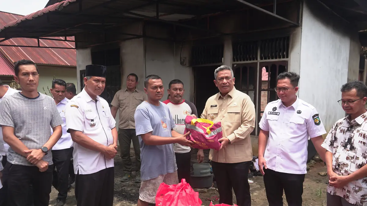  Bupati Rohul Anton ST MM menyerahkan secara simbolis bantuan sandang dan pangan kepada korban yang rumahnya terbakar di lingkungan Lenggopan, Kelurahan Pasirpengaraian, Kecamatan Rambah, Rabu (1/4/2026). (Prokopim Setda Rohul)
