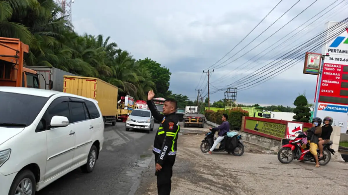 Personil Sat Lantas Polres Pelalawan mengatur arus lalu lintas di SPBU PT Jawara Energy Semesta 14.283.666 Jalintim tepatnya didekat RS Efarina Pangkalan Kerinci, Rabu (29/4/2026). (Amin/Riaupos.co)