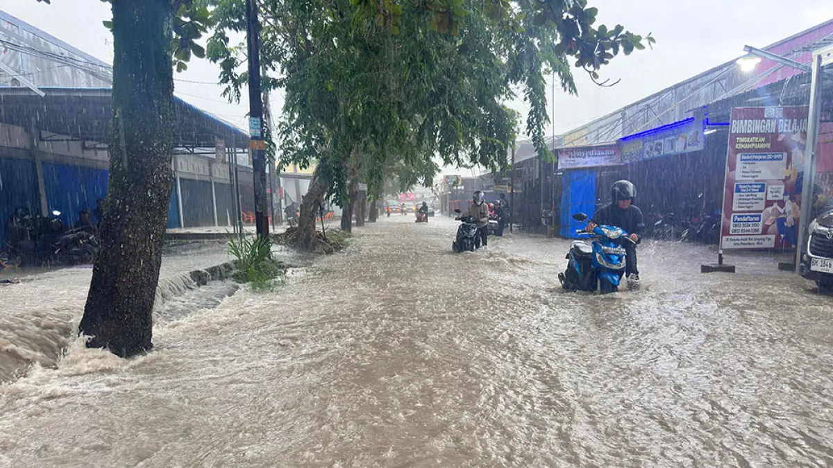 Sejumlah pengendara terpaksa mendorong sepeda motor yang mogok setelah melewati genangan di Jalan Kusuma, Kecamatan Bukitraya, Senin (4/5/2026). (prapti dwi lestari)