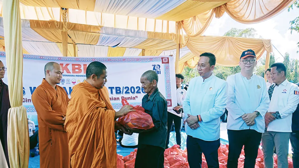 Para biksu yang ikut dalam Dharmayatra menyerahkan paket bantuan sembako kepada masyarakat kurang mampu yang ada di sekitar Candi Muara Takus, Ahad (17/5/2026). (Prapti Dwi Lestari)