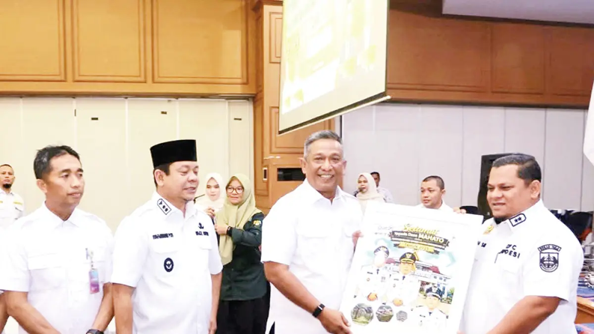Bupati Rohul Anton didampingi Wabup Rohul H Syafaruddin Poti menyerahkan penghargaan kepada Kades Mahato Firiadi, atas realisasi PBB P2 tertinggi se-Rohul tahun 2025 dalam acara penyerahan SPPT PBB P2 di Convention Hall Islamic Center Rohul, baru baru ini. (Foto Dinas Kominfo Rohul)