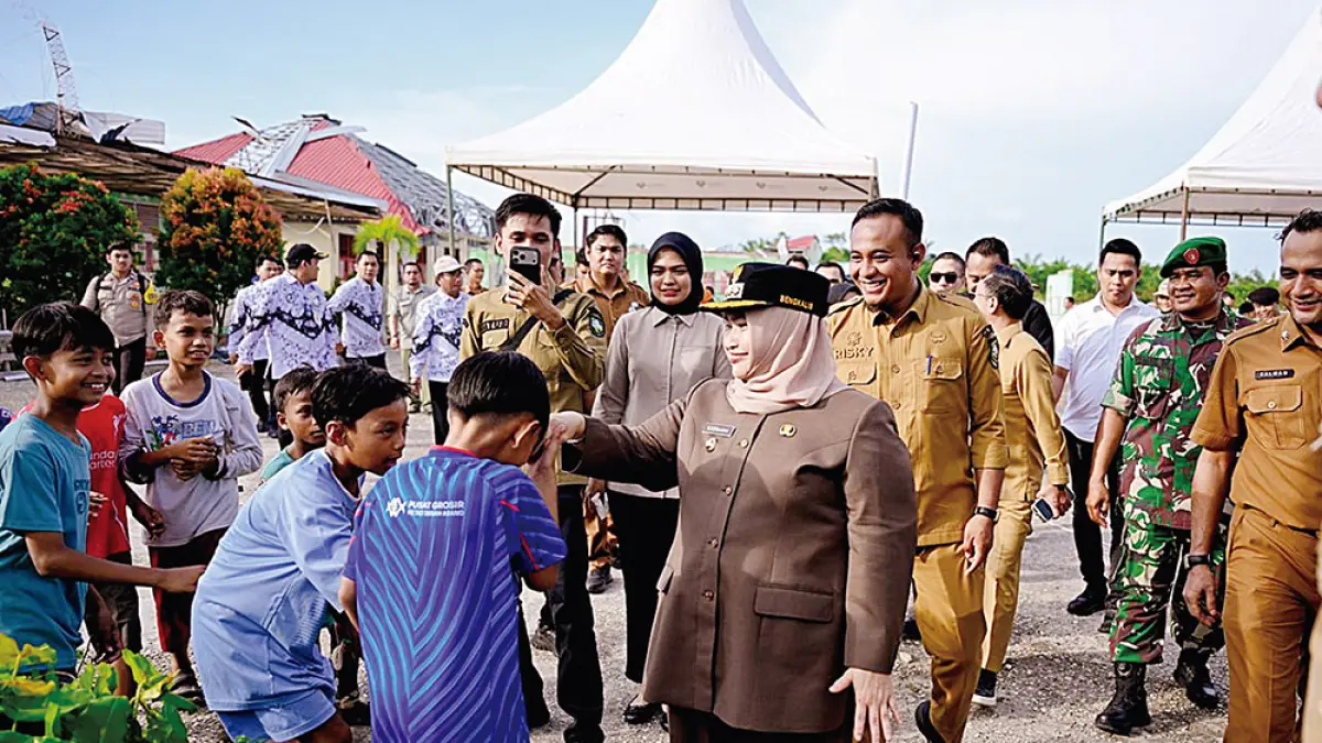 SALAMI PELAJAR: Bupati Bengkalis Kasmarni menyalami dan memberi semangat pelajar saat meninjau SMPN1 Bandar Laksamana yang rusak diterjang angin puting beliung di Desa Apiapi, Kecamatan Bandar Laksamana, Selasa (9/6/2026). (PEMKAB BENGKALIS UNTUK RIAU POS)
