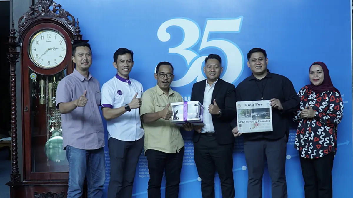 GM FOX Hotel Pekanbaru Dedi Saputra (tiga kanan) didampingi Marketing Branding Manager Peli Perdana Lauser Rianas, Food and Beverage Manager May Nurdin menyerahkan kue tar kepada Direktur Riau Pos Asmawi Ibrahim (tiga kiri) didampingi staf Divisi iklan Aldi (kiri) dan Dewi Susanti (kanan) saat kunjungan FOX Hotel Pekanbaru ke Riau Pos, Selasa (30/6/2026). (MHD AKHWAN/RIAUPOS)
