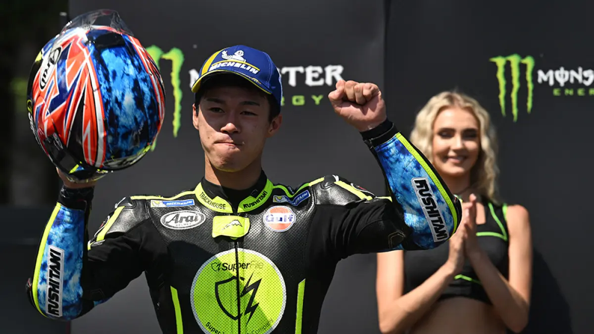 Pembalap tim Trackhouse Racing MotoGP, Ai Ogura, merayakan keberhasilannya di podium setelah finis di posisi kedua pada Grand Prix MotoGP Ceko di Brno, Republik Ceko, beberapa waktu lalu. (Michal Cizek/AFP)