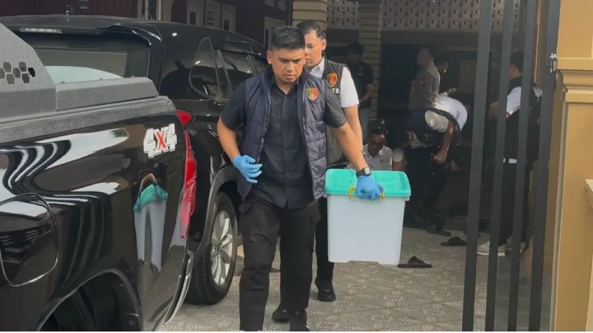 Tim Tipidkor Satuan Reskrim Polres Siak membawa barang bukti dalam kotak kontainer dari kediaman Kadishub yang terkena OTT Rp15 juta di Jalan Sutomo, Kelurahan Kampung Dalam, Siak Kota, Senin (14/7/2026). (Monang Lubis/Riaupos.co)
