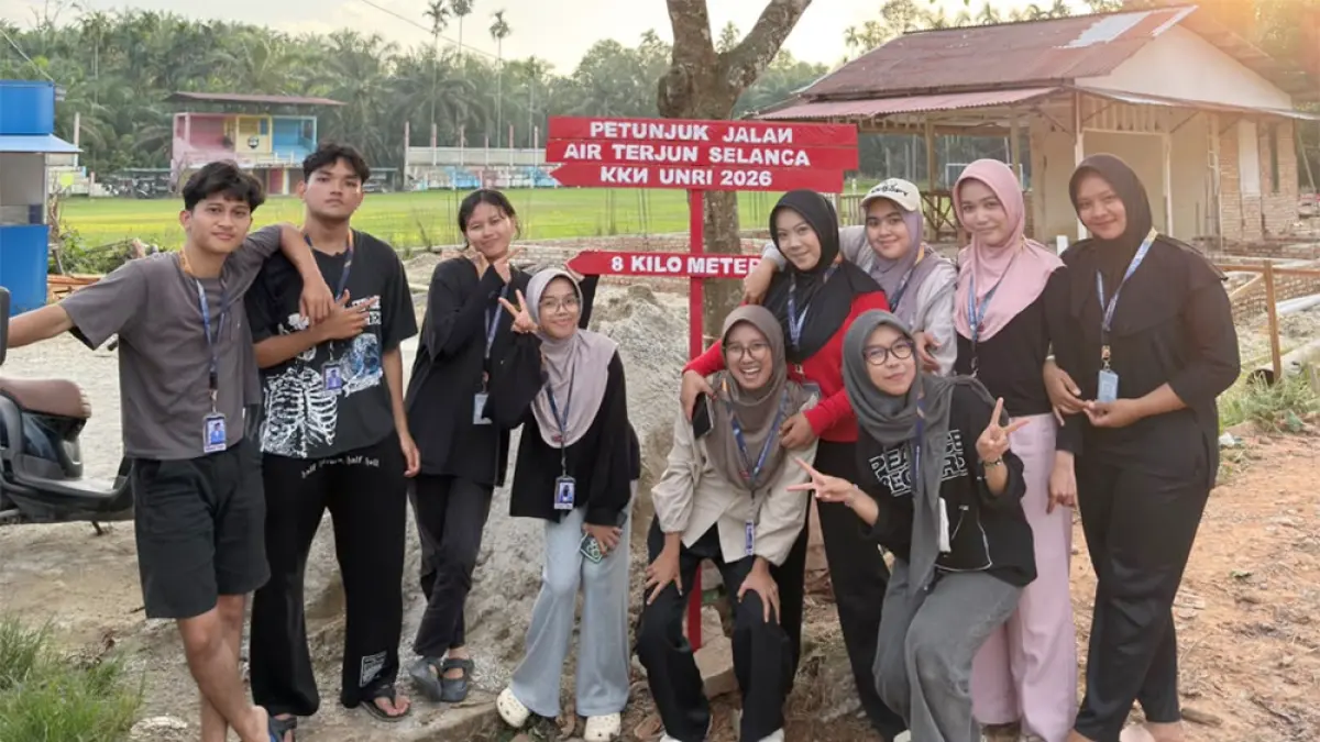 Mahasiswa KKN UNRI Tahun 2026 foto bersama saat memasang papan petunjuk jalan menuju objek wisata Air Terjun Selanca di Desa Lubuk Bendahara, Kabupaten Rokan Hulu, Rabu (8/7).