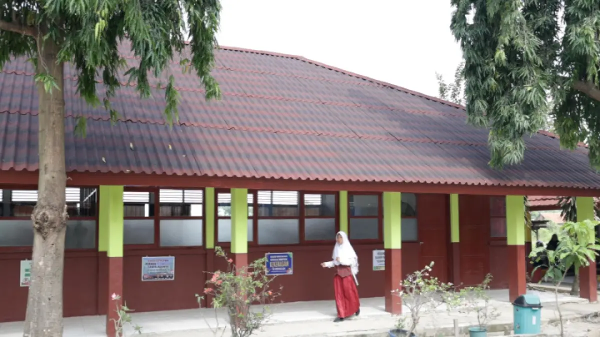 Murid SD berjalan di teras sekolahnya yang baru direvitallisasi. (Dok Jawapos.com)