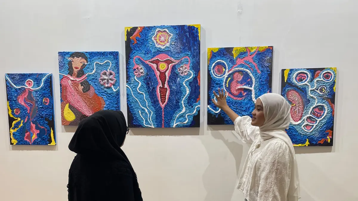 alah seorang seniman yang ikut pameran di Artis Art Fair Pekanbaru 2026, Melisa Nofem (kanan), saat menjelaskan konsep karyanya kepada salah seorang pengunjung di Ruang Pameran Khusus Museum Sang Nila Utama Riau, Pekanbaru, Senin (29/6/2026) lalu. Hary B Koriun/Riau Pos