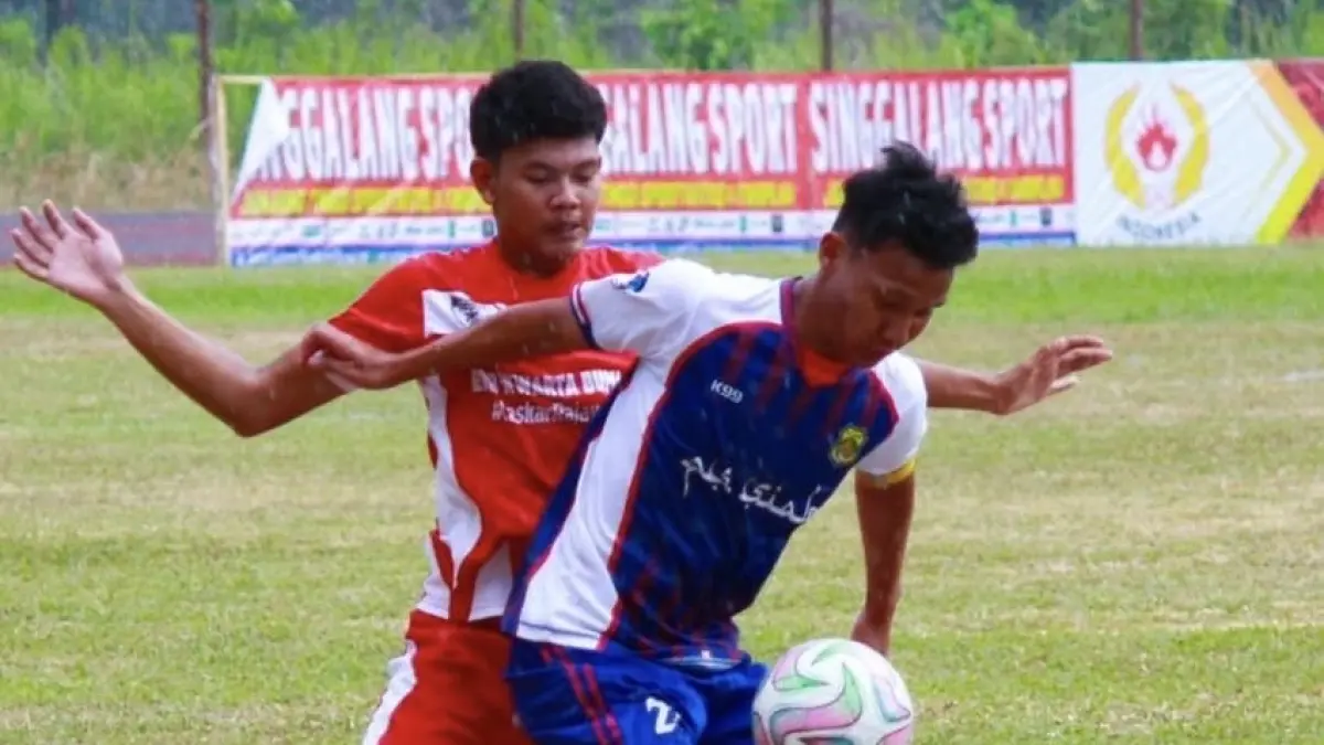 Kapten PS Siak Rayyan (depan) menggocek bola saat bertanding melawan Tim Kwarta Bumi Riau (KBR) dan berhasil memenangkan pertandingan menuju semifinal Piala Soeratin U-17 dengan skor skor 5-4 di Stadion Batu Canai, Inhu, Selasa (4/8/2026).