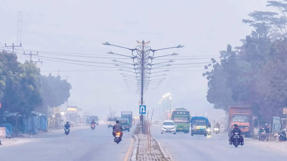 Kabut asap akibat kebakaran hutan dan lahan menyelimuti kawasan Jalan Raya Pekanbaru-Bangkinang, Ahad (23/8/2026). Kondisi ini membuat kualitas udara di Pekanbaru berstatus tidak sehat.(EVAN GUNANZAR/RIAU POS)