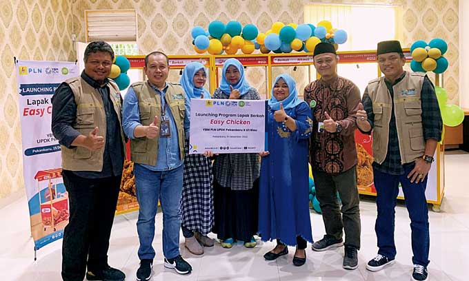 General Manager PT PLN Unit Induk Pembangkitan Sumatera Bagian Utara (UIK SBU) Purnomo (dua kanan) tampak foto bersama dengan penerima manfaat Easy Chicken, Jumat (16/12/2022).