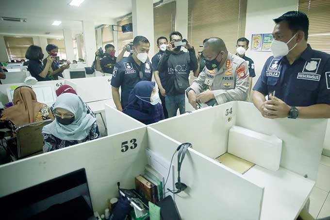 Petugas kepolisian mengamankan 56 orang karyawan saat penggerebekan kantor pinjaman online yang tak terdaftar di Otoritas Jasa Keuangan (OJK) di Cipondoh, Kota Tangerang, Banten, Kamis (14/10/2021).
