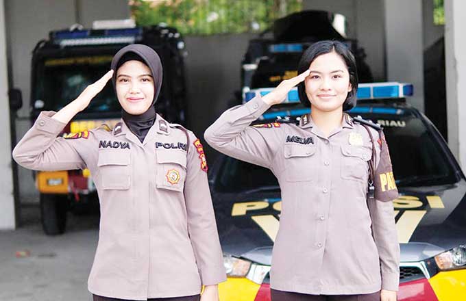 Anggota Polwan dari Direktorat Shabara Polda Riau Bripda Melva Natalia Siregar dan Bripda Nadya Wulandari foto beri hormat, Kamis (1/9/2022).