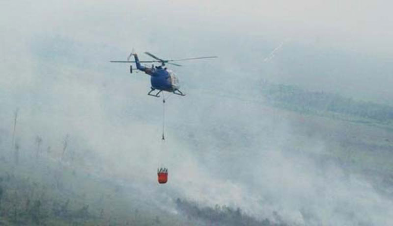 Helikopter membawa bom air untuk memadamkan kebakaran hutan dan lahan di Provinsi Riau.