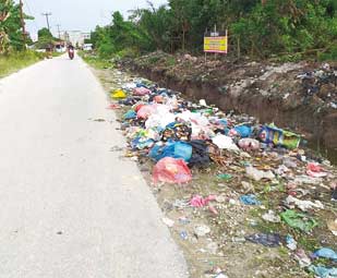 BERSERAKAN: Tumpukan sampah yang berserakan di jalan Wajib Senyum Kecamatan Pangkalan Kerinci. Namun tidak ada dilakukan pembersihan oleh dinas terkait sehingga menyebabkan terganggunya aktifitas warga yang melintas, Kamis (10/1/2019). (M AMIN AMRAN/RIAU