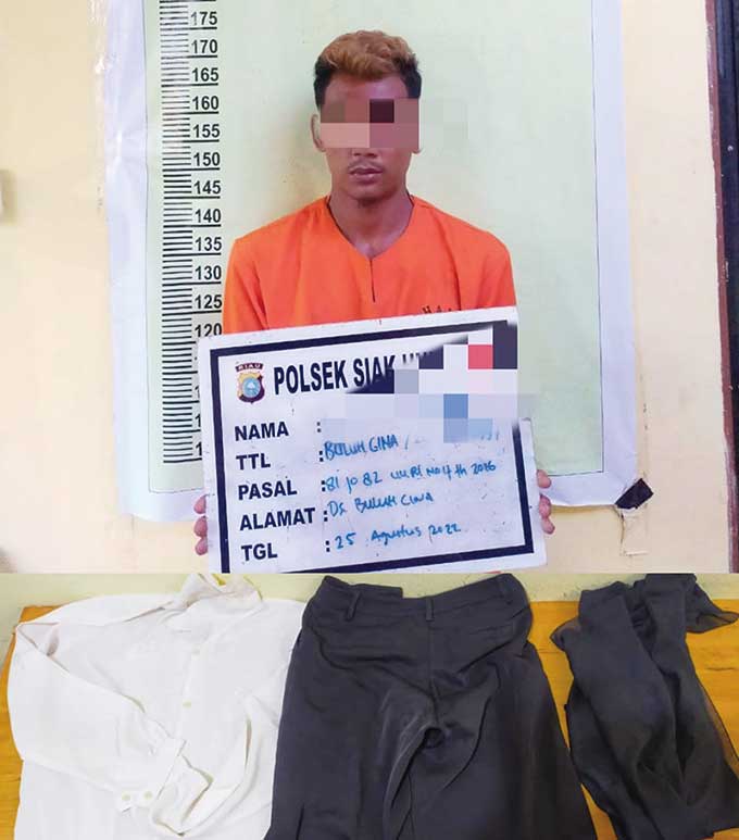 Tersangka dugaan pencabulan saat mendekam di terali besi Mapolsek Siak Hulu. Foto diambil beberapa waktu lalu.