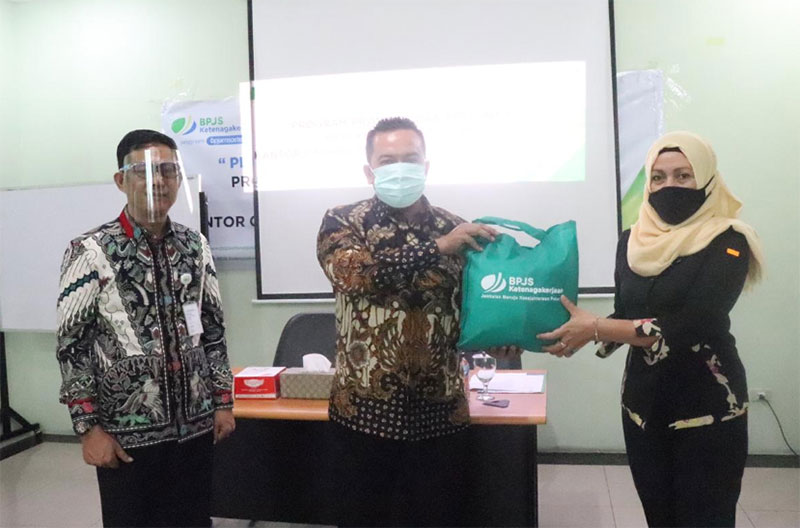 Deputi direktur BP Jamsostek Sumbarriau Pepen S Almas didampingi kepala cabang Pekanbaru kota Mias Muchtar menyerahkan masker dan multivitamin kepada perwakilan peserta BP Jamsostek, Rabu (1/7/2020).(BPJAMSOSTEK FOR RIAUPOS.CO)