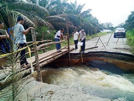 JALAN PUTUS:  Pihak Dinas Pekerjaan Umum dan Penataan Ruang (PUPR) Provinsi Riau melakukan peninjauan dan pengukuran jalan Pekan Heran-Mumpa yang putus akibat banjir, Rabu (12/12/2018). (KASMEDI/RIAU POS).