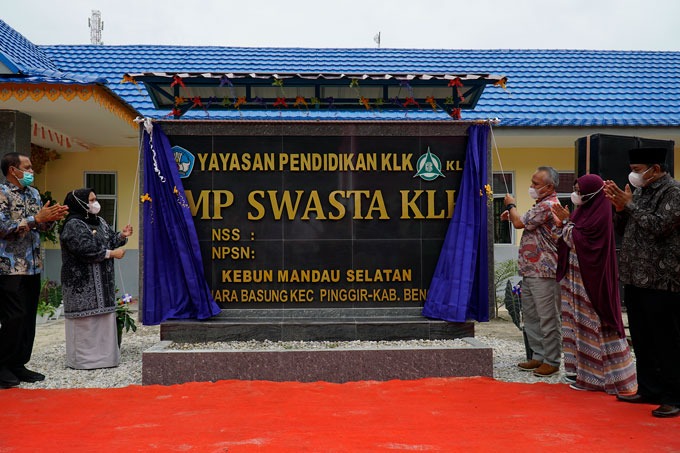 Bupati Bengkalis Kasmarni, SSos MMP saat membuka tirai plang SMP Swasta KLK didampingi Senior Manajer Kebun Mandau PT Adei Plantation and Industry Heru Andoyo SP dalam program CSR perusahaan tersebut di Kebun Mandau Selatan, Kelurahan Muara Basung, Kecama