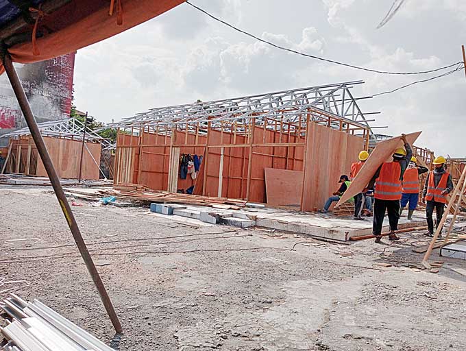 Para pekerja mulai proses memasang dinding tripleks untuk kios TPS Pasar Cik Puan, Jumat (17/3/2023). Ditargetkan,TPS sudah selesai sehari sebelum Ramadan 1444 H.