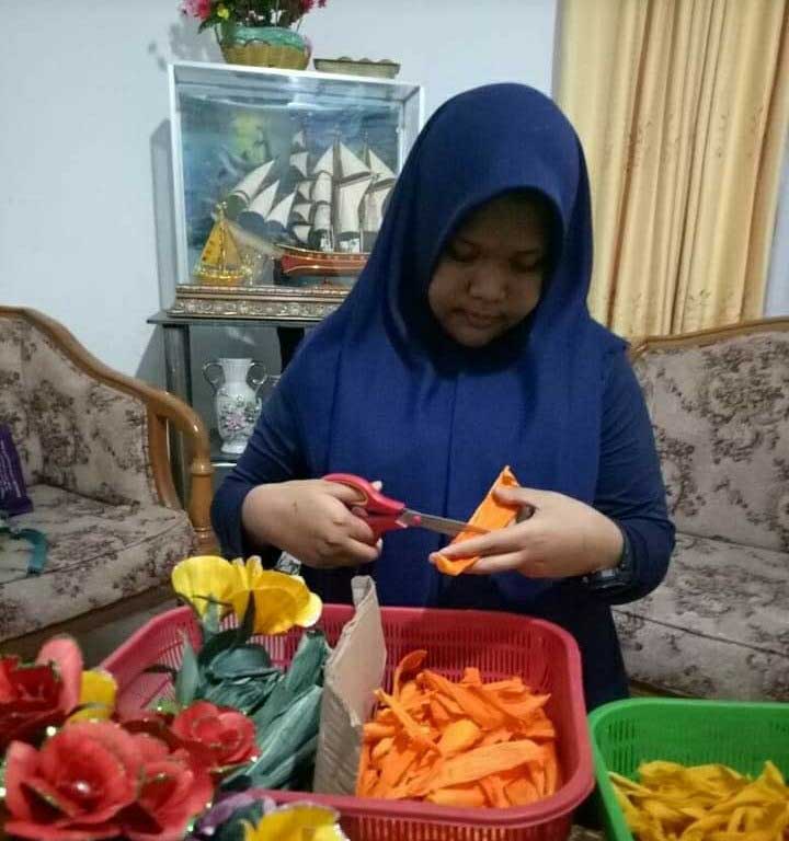 Salah seorang anak Linda tampak tengah membuat bunga dari limbah kulit jagung di rumahnya Jalan Sei Mintan, Kelurahan Air Dingin, Kecamatan Bukitraya, Kamis (8/4/2021).