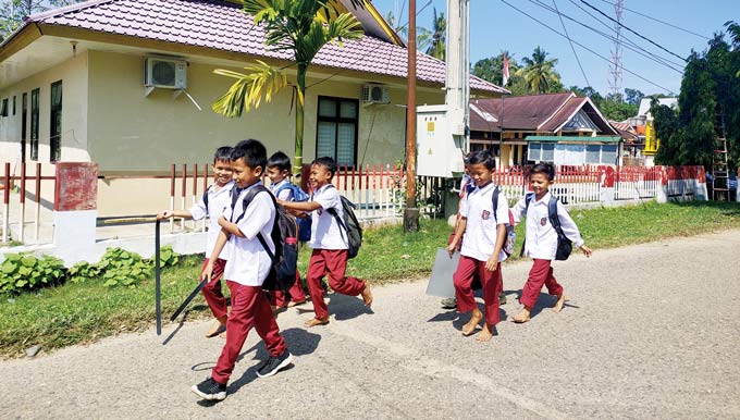 Murid SD di Desa Lubuk Ambacang, Hulu Kuantan, Kuansing terlihat ceria saat pulang sekolah, beberapa waktu lalu. Pemerintah mengembalikan libur sekolah sesuai dengan kalender pendidikan.