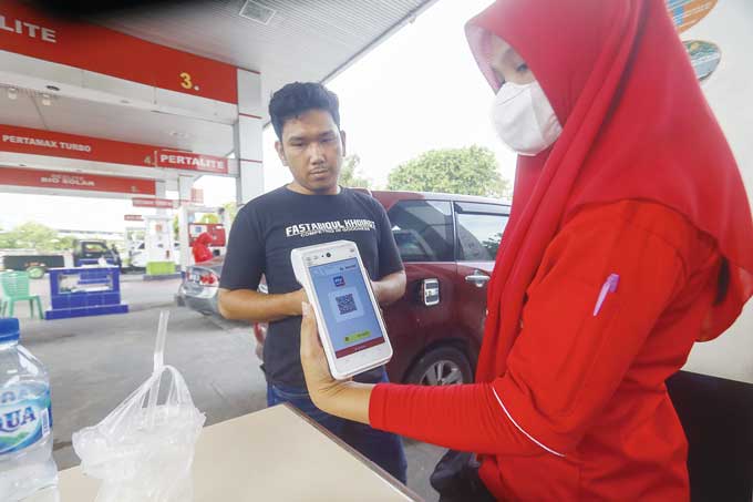 Petugas SPBU memperlihatkan Aplikasi MyPertamina yang digunakan pengendara roda empat untuk mengisi BBM bersubsidi, baru-baru ini. Pembelian BBM subsidi jenis solar diwajibkan pakai barcode mulai Selasa (28/3/2023).