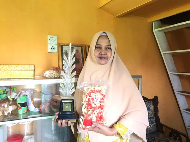 Pemilik Amplang Udang Kembar, Tembilahan memperlihatkan produk dan penghargaan yang diraihnya.