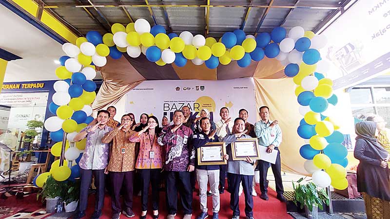 Kepala Kantor Wilayah (Kakanwil) Direktorat Jenderal Pajak (DJP) Provinsi Riau Ahmad Djamhari (tengah), Kepala KPP Pratama Bangkinang Meidijati (batik orange) berfoto bersama jajaran Kemenkeu 1, perwakilan UMKM dan perbankan dalam kegiatan bazar UMKM seka