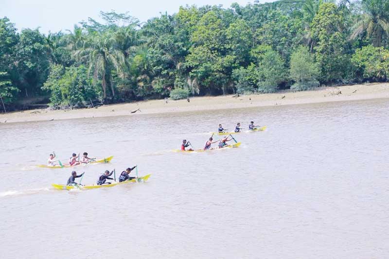 Para peserta lomba memacu sampan menyusuri Sungai Siak dalam Festival Pacu Sampan Tradisional di Pulau Semut, Kelurahan Limbungan, Rumbai Timur, Jumat (4/8/2023).