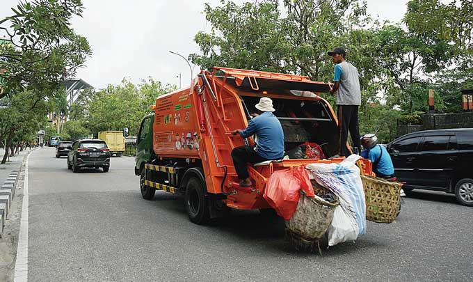Pekerja mengangkut sampah perkotaan dengan armada terbaru yang lebih efisien milik Pemerintah Kota Pekanbaru, beberapa hari lalu. Memasuki akhir tahun, volume sampah di Kota Pekanbaru meningkat dari 850 ton menjadi 1.000 ton per hari.