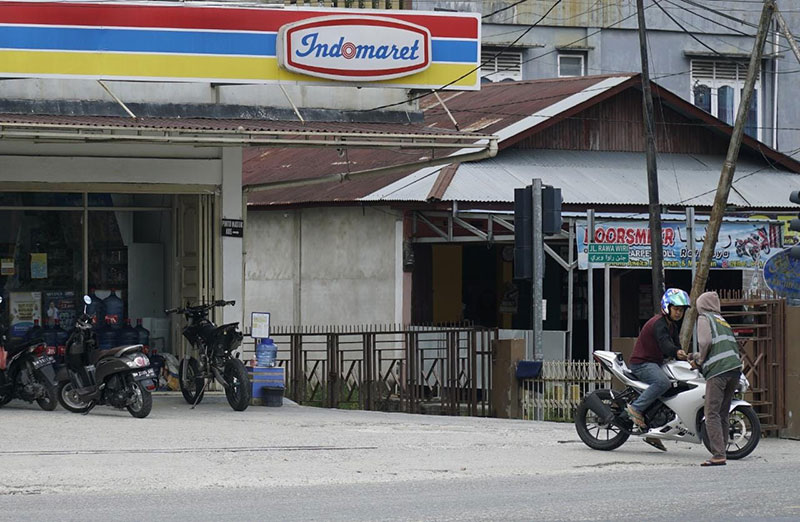 Juru parkir meminta uang parkir di salah satu gerai Indomaret, baru-baru ini.