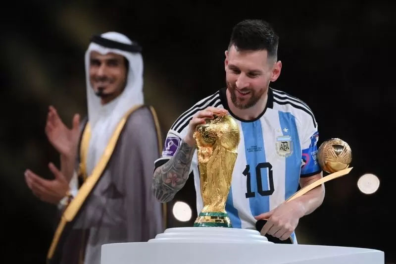 Mega bintang Argentina Lionel Messi menyentuh trofi Piala Dunia setelah menerima anugerah Pemain Terbaik di Piala Dunia 2022 Qatar pada 18 Desember 2022.