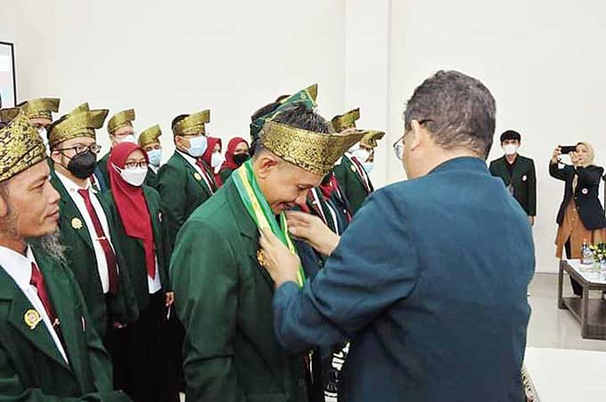 Ketua IDI Wilayah Provinsi Riau dr Zul Asdi SpB MKes MH mengalungkan syal kepada Ketua IDI Cabang  Inhu dr Rudi Ardhian pada prosesi pelantikan, Sabtu (24/9/2022).