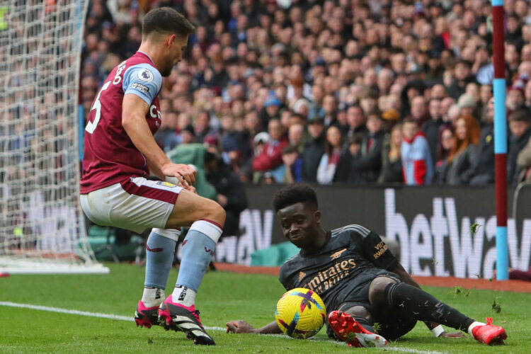 Gelandang Arsenal Bukayo Saka (kanan) terjatuh di hadapan bek Aston Villa Alex Moreno dalam laga di Villa Park, Sabtu (18/2/2023).