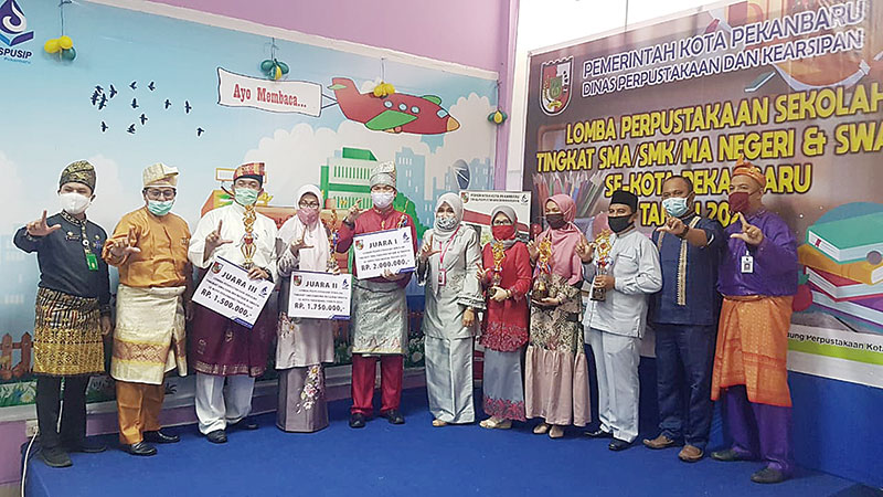 Sekolah pemenang lomba Perpustakaan Sekolah tingkat SMA/SMK/MA Negeri dan Swasta se-Kota Pekanbaru foto bersama dengan Kepala Dinas Perpustakaan dan Kearsipan Kota Pekanbaru Ir Hj Nelfiyonana MSi dan dewan juri usai penyerahan hadiah, Selasa (16/6/2020).(