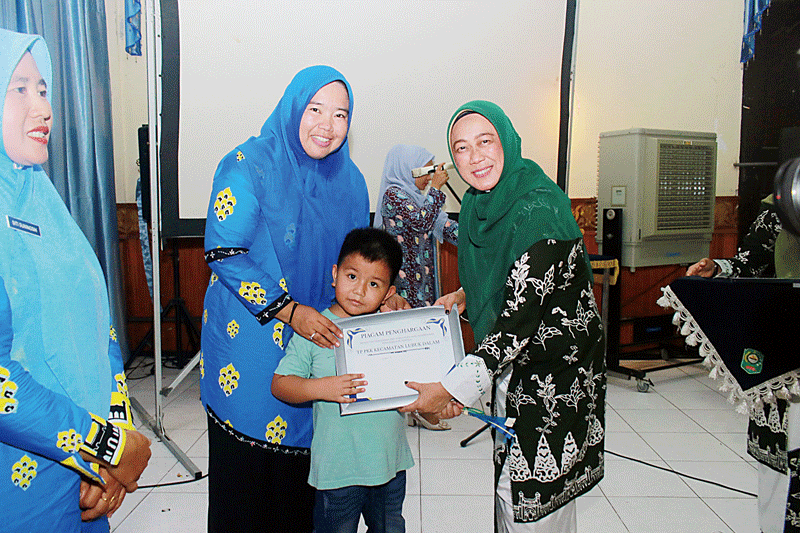 Ketua TP PKK Siak Rasidah Alfedri menyerahkan piagam penghargaan kepada perwakilan TP-PKK Lubuk Dalam di Gedung Tengku Mahratu Siak pada Sabtu (16/9/2023).