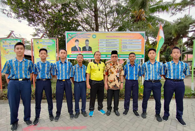 Kepala SMPN 13 Pekanbaru Zurdianto MPd (empat kanan) bersama guru olahraga Agusnil SPd (lima kiri) foto bersama dengan siswa berprestasi nasional setelah mendapat apresiasi dan pembekalan di halaman sekolah, beberapa waktu lalu.