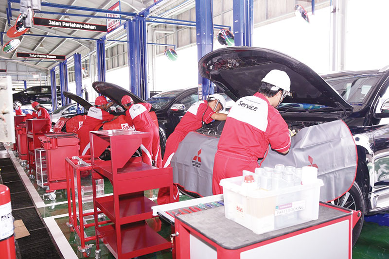 CEK MESIN: Mekanik Mitsubishi Motors mengecek kondisi kendaraan yang terdampak banjir di diler resmi Mitsubishi, Jakarta, Ahad (5/12/2020). (PT MMKSI for riau pos)